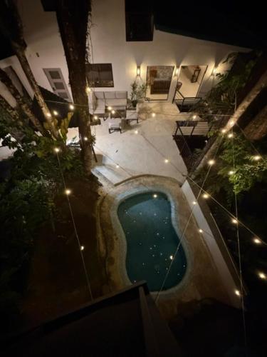 an overhead view of a swimming pool at night at Sal y Sol in Quepos