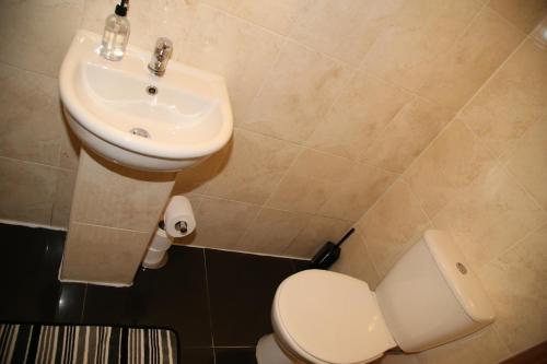 a bathroom with a toilet and a sink at A Gosport Inn - Free Private Parking in Gosport