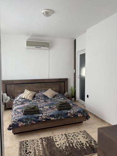 a bedroom with a bed with a blue comforter at Casa Di Pafcho - Balchik Villa Retreat in Balchik