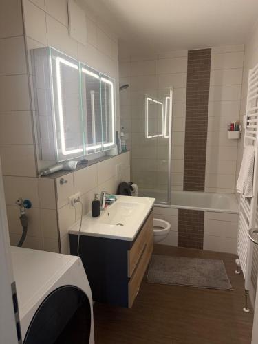 a bathroom with a sink and a tub and a toilet at Ori's apartment in Frankfurt