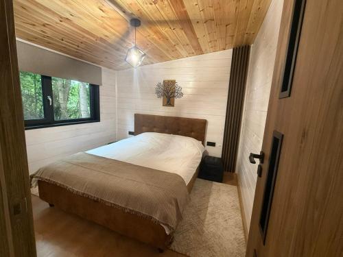 a bedroom with a bed in a small room at Wild Crib Avrig in Avrig