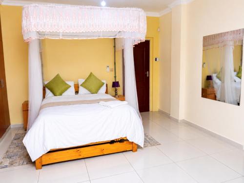 a bedroom with a bed with a canopy at JAC Tilama BNB Villa-3 Bedroom in Blantyre