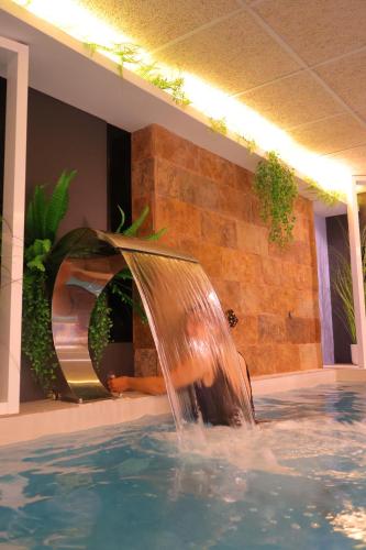 a water fountain in a pool in a house at Hotel SPA GBC Avenida Pontevedra in Pontevedra