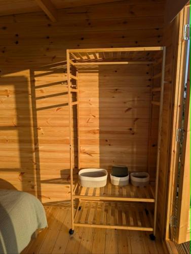 a wooden room with a sauna with two shelves at Skyline cabin in Bugle