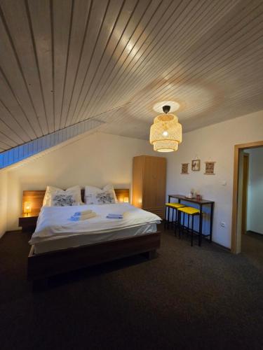 a bedroom with a large bed with a wooden ceiling at LS Apartments Štefanová in Terchová