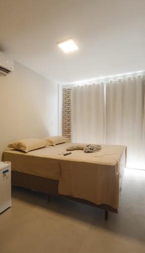 a bedroom with a bed in a white room at Atins Ville Lençóis in Atins