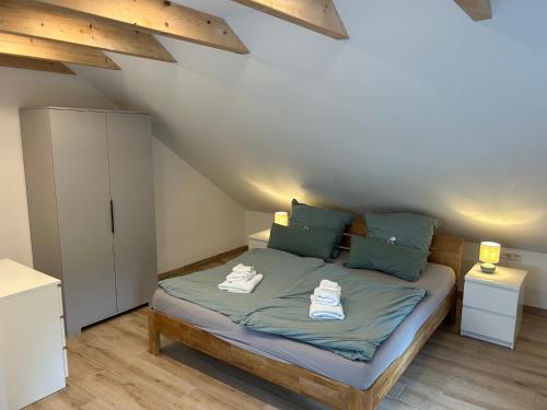 a bedroom with a bed with two towels on it at MainSpessartBlick in Lohr am Main