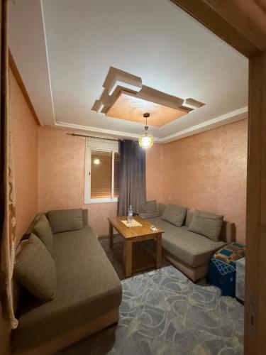 a living room with a couch and a table at Sunset Stay Anza in Agadir