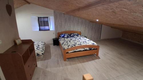 a bedroom with two beds in a attic at Chez Nova in Chaudenay