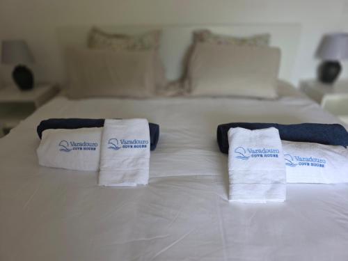 a bed with two towels on top of it at Varadouro Cove House in Horta