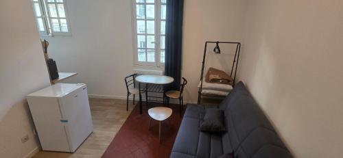 a living room with a couch and a table at Olti in Avignon