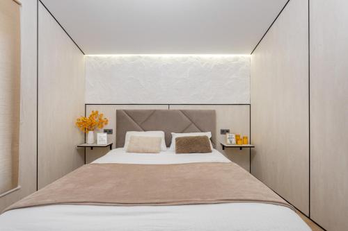 a bedroom with a large bed with two pillows at Басейн Чан с Джакузи Дом Посуточно Осокорки Киев in Kyiv