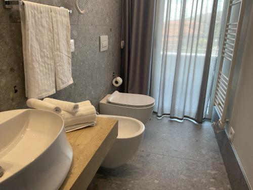 a bathroom with a sink and a toilet and a window at VILLA ACTEA in Vasto