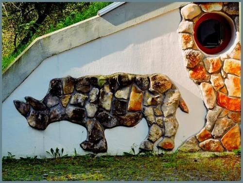 a painting of a dog on the side of a building at Kaláris Vendégház in Hollókő