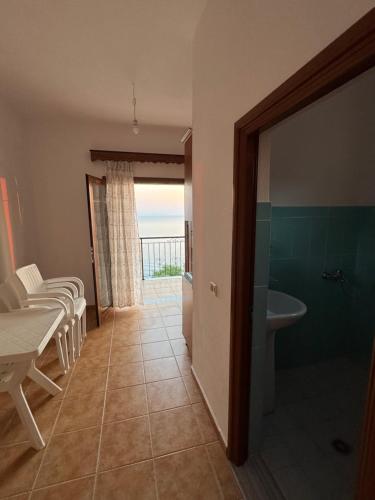 a bathroom with a sink and a toilet and a tub at Villa Denis Gjeta in Borsh
