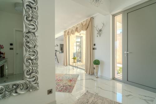 a hallway of a home with a mirror on the wall at Villa Oasis mit Meerblick in Supetar