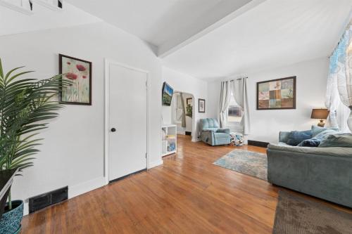 a living room with a couch and a table at 4BR Home Across from Como Lake - Evergreen in Saint Paul