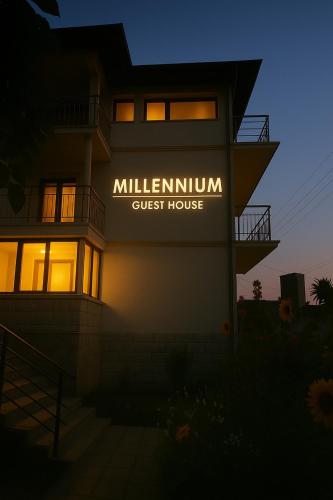a building with a sign that reads millenium guest house at Millennium Guest House in Kŭrdzhali