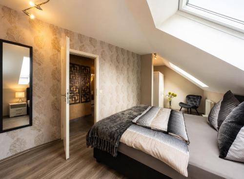 a bedroom with a large bed and a mirror at Lifestyle in Kurort Steinbach-Hallenberg