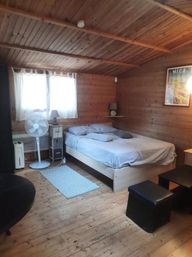 a bedroom with a bed in a wooden room at Chalet au centre de Nice in Nice