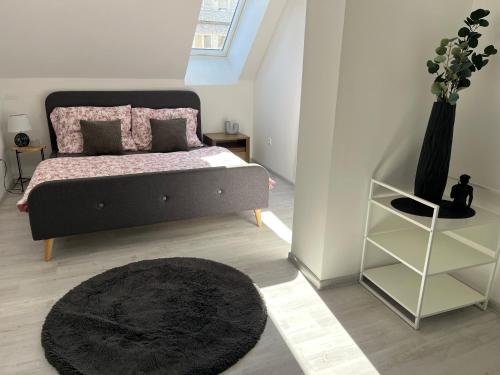 a bedroom with a bed and a black rug at Apartment AFRODITA Trnava - Historic centre in Trnava