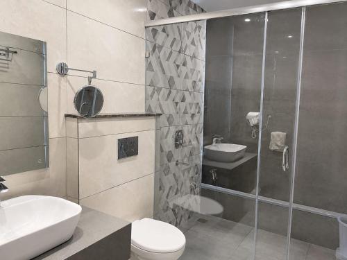 a bathroom with a shower and a toilet and a sink at The Sky Deck in Haldwāni