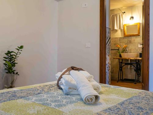 a pile of towels sitting on top of a bed at L'Uggetto in Montecastrilli
