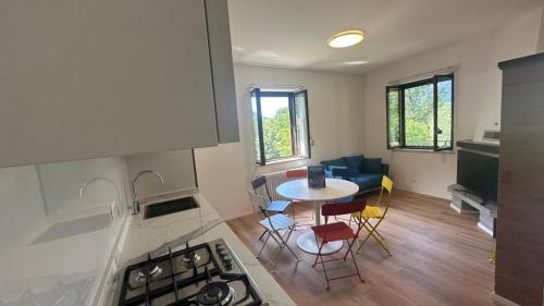 a kitchen and dining room with a table and a stove at A lì dai Nûtis in Venzone
