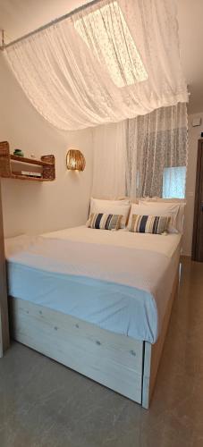 a bedroom with a bed with a canopy and a window at VALEXX luxury studio in Perea