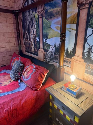 a bedroom with a bed with a painting on the wall at Harry Potter feature room- Warner bros studios in Watford