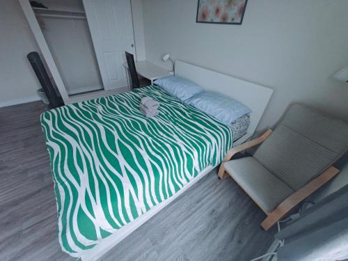 a bedroom with a bed and a chair at Central Light-Filled 3rd Floor -3C in Halifax