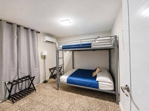 a bedroom with a bunk bed with a dog laying on it at Casita Velera in Lajas