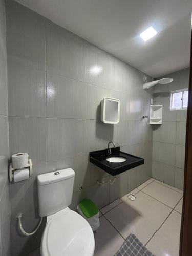 a bathroom with a toilet and a sink at Pousada Ramon in Remígio