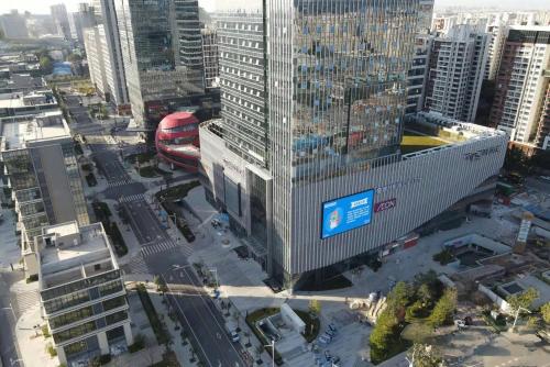 an overhead view of a city with a red train at ChillNow Hotel Guangzhou in Guangzhou
