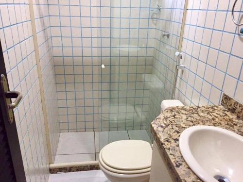 a bathroom with a shower with a toilet and a sink at Solar dos Anjos in Arraial do Cabo