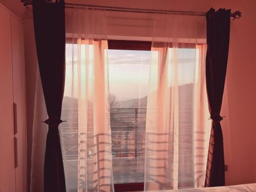 a bedroom with a window with a view at Milmari N2 Erdeg in Kopaonik