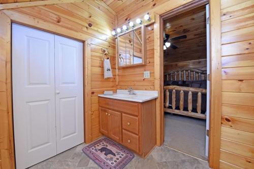 a bathroom with a white door and a sink at S'more Waggin' Cabin: Pet-Friendly--wifi, firepit, pool table in Blue Ridge