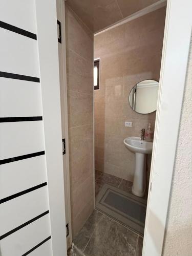 a bathroom with a sink and a toilet and a mirror at Kaganat village in Uchar