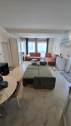 a large living room with a couch and a table at CANj LOUNGE STUDIO in Čanj