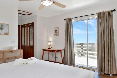a bedroom with a bed and a large window at Amethyst Dunes by Pristine Properties Vacation Rentals in Indian Pass
