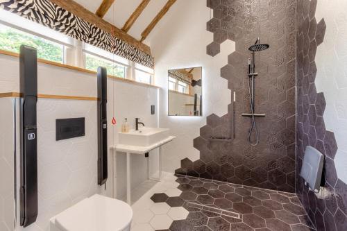a bathroom with a shower and a toilet and a sink at 11 Bed in Stebbing oc-p34450 in Stebbing