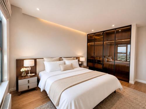 a bedroom with a large white bed and a window at Mandala 365 Residential Tower in Ulaanbaatar