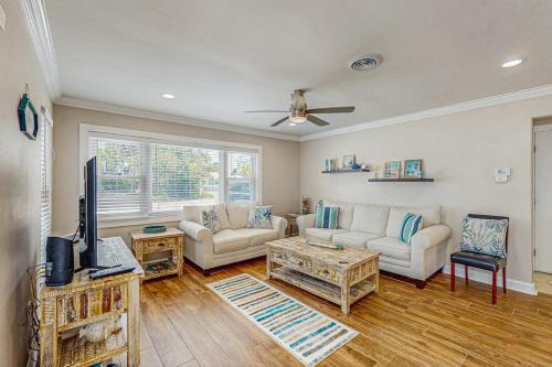 a living room with two couches and a tv at Sea Pirate 1 in Holmes Beach