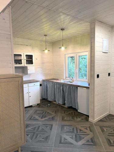 a kitchen with a table in the middle of a room at Sosenkowe Zacisze in Ciche