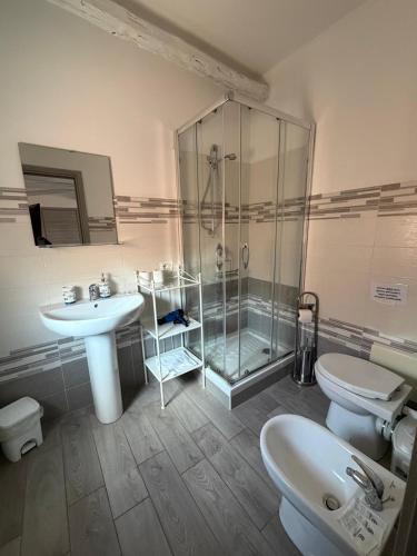 a bathroom with a shower and a sink and a toilet at La Conchiglia 2.0 in Soverato Marina