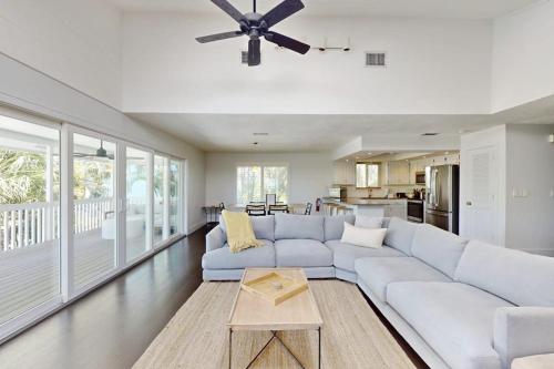 a living room with a white couch and a table at Spring Oasis in Anna Maria