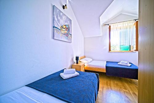 a small room with two beds and a window at Villa Valentina with pool and close to beach in Selca