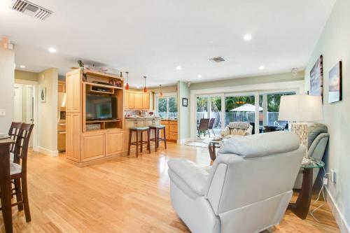 a living room with a white couch and a kitchen at Almost There in Bradenton