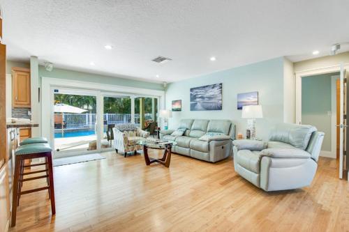 a living room with two couches and a table at Almost There in Bradenton