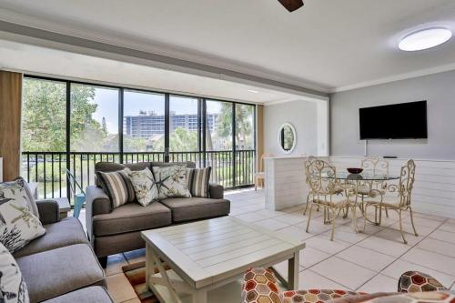 a living room with a couch and a table at Midnight Cove II 823 in Siesta Key